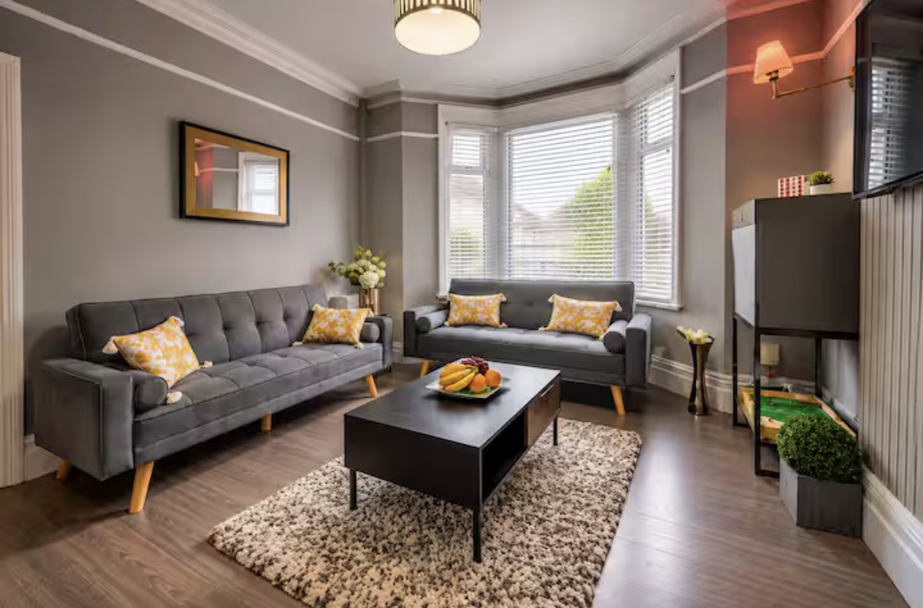 Two grey sofas around a coffee table in a bright lounge